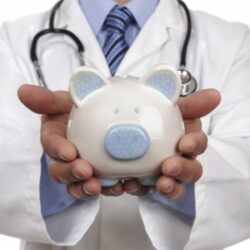 A physician holding a piggy bank